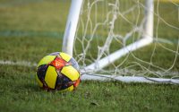 red blue and yellow soccer ball on green grass field