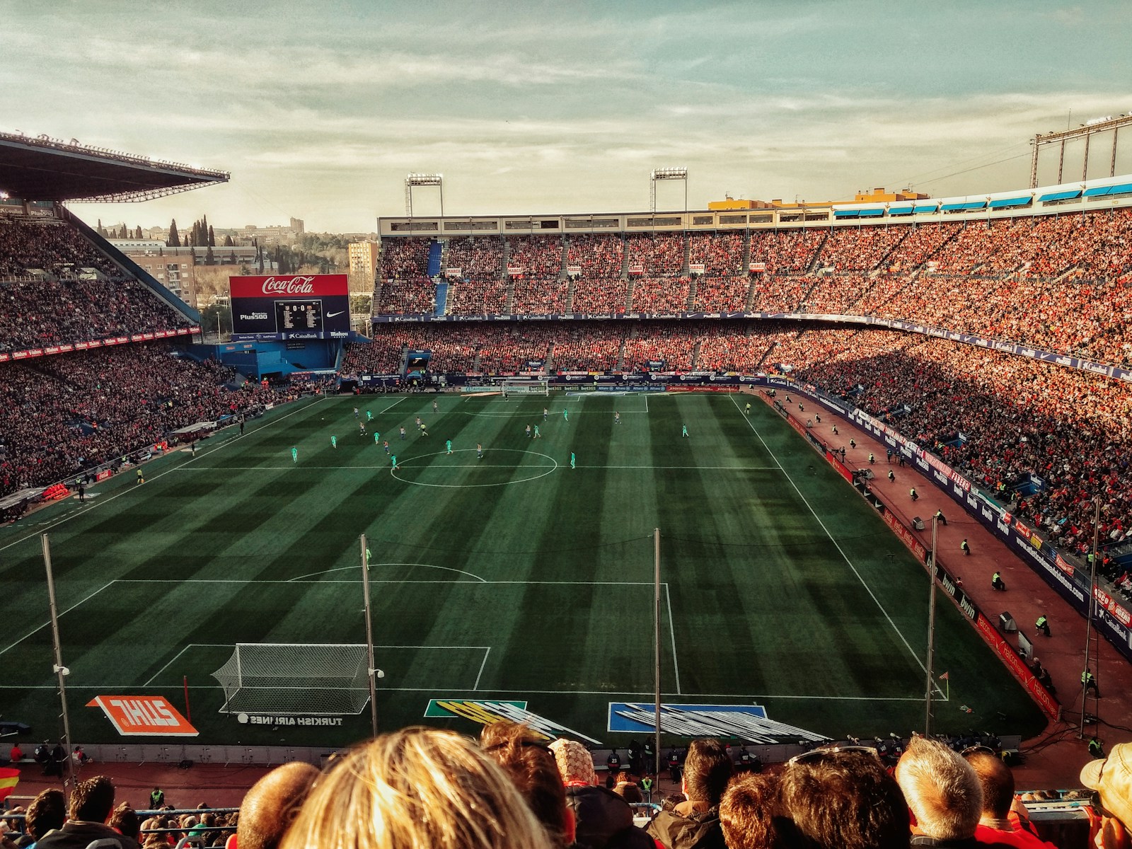 green soccer field with crowd at daytime